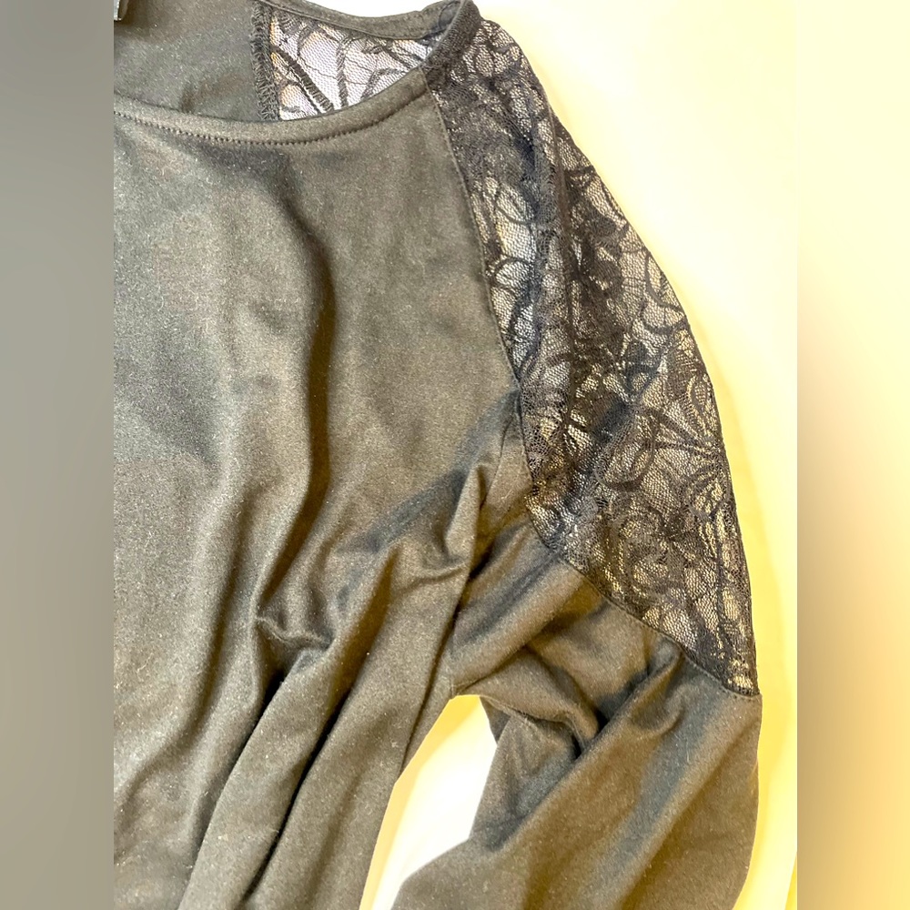 Gray sweater with lace shoulders.